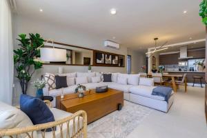 a living room with a couch and a table at New Luxury PH 4BR Cabo in Cabo San Lucas