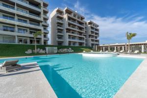 a swimming pool in front of a large apartment building at New Luxury PH 4BR Cabo in Cabo San Lucas