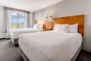 a hotel room with two beds and a window at Hyatt Place Salt Lake City Airport in Salt Lake City