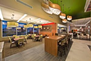 a dining area with tables and chairs in a restaurant at Hyatt Place Bayamon in Bayamón