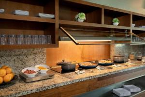 a kitchen with bowls of food on a counter at Hyatt Place Bayamon in Bayamón