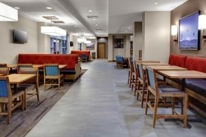 a dining room with wooden tables and chairs at Hyatt Place Columbus in Columbus