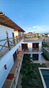 a view of a building with the ocean in the background at Pousada Solarium in Canoa Quebrada