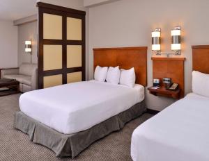 a hotel room with two beds and a chair at Hyatt Place Garden City in Garden City +51 photos