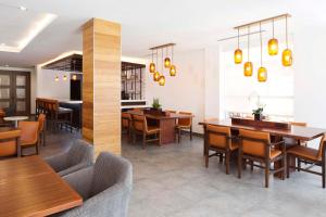 a dining room with wooden tables and chairs at Hyatt House Dallas / Frisco in Frisco