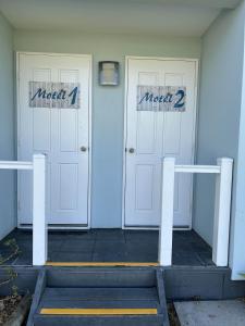 two white doors with the words macy two at Mandurah Coastal Holiday Park in Mandurah