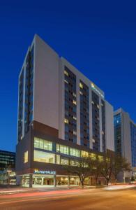 a large building with lights on in a city at Hyatt Place Houston Galleria in Houston