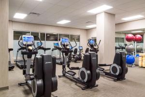 a gym with a row of treadmills and exercise bikes at Hyatt House Denver Downtown in Denver