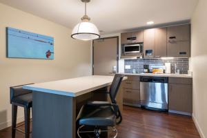 a kitchen with a table and chairs in a room at Hyatt House Denver Downtown in Denver