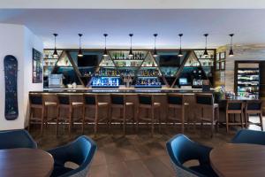 a bar at a restaurant with tables and chairs at Hyatt House Denver/Downtown in Denver