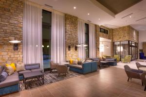 a lobby with couches and chairs and a brick wall at Hyatt Place Park City in Park City