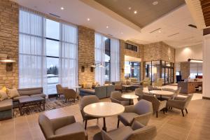 a lobby with tables and chairs and windows at Hyatt Place Park City in Park City