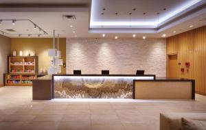 a lobby with a reception desk in a building at Hyatt House at Anaheim Resort/Convention Center in Anaheim