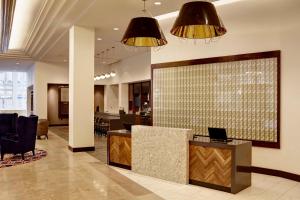 a lobby with a reception desk and two lights at Hyatt Place St. Paul in Saint Paul