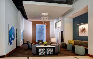 a lobby with a couch and a table at Hyatt Place Arlington Courthouse in Arlington