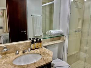 a bathroom with a sink and a shower at Hotel America International Jardins in Sao Paulo