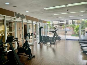 a gym with treadmills and ellipticals in a building at Hotel America International Jardins in Sao Paulo