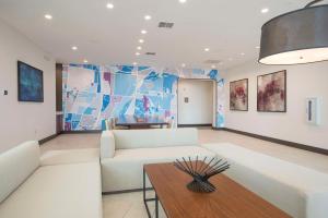 a living room with a white couch and a table at Hyatt Place Cincinnati/Sharonville Convention Center in Sharonville
