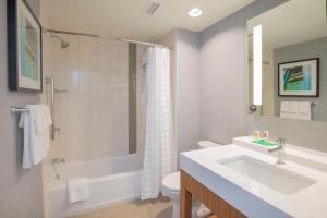 a bathroom with a sink and a tub and a toilet at Hyatt Place Cincinnati/Sharonville Convention Center in Sharonville
