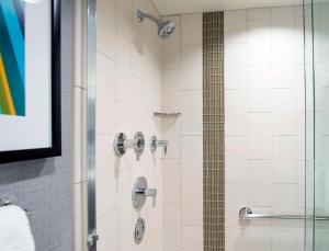 a shower with two faucets in a bathroom at Hyatt Place Cincinnati/Sharonville Convention Center in Sharonville