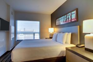 a hotel room with a large bed and a window at Hyatt House Chicago/Evanston in Evanston