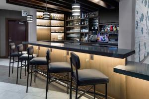 a bar with a row of chairs in a restaurant at Hyatt Place Dallas/Allen in Allen