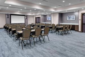 a conference room with tables and chairs and a screen at Hyatt Place Dallas/Allen in Allen