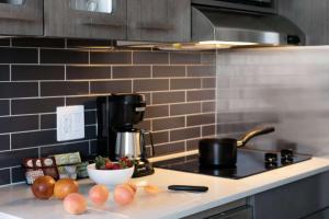 a kitchen counter top with a bowl of fruit on it at Hyatt House New York/Chelsea in New York