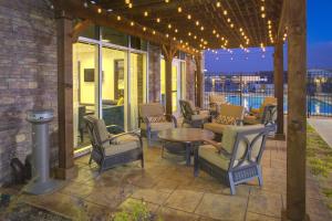 a patio with chairs and a table and lights at Hyatt Place Dallas/The Colony in The Colony