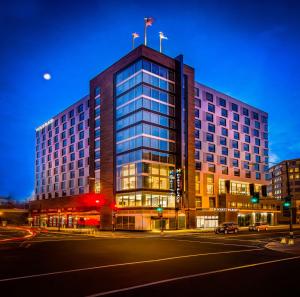 a tall building with two flags on top of it at Hyatt Place Washington D.C./National Mall in Washington