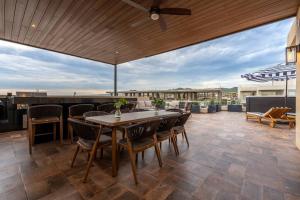 a patio with a table and chairs on a roof at Villa San Lucas - Luxury 4BR Penthouse in Cabo San Lucas