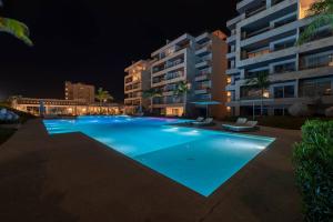 a large swimming pool in front of a building at night at Villa San Lucas - Luxury 4BR Penthouse in Cabo San Lucas