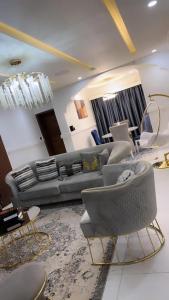 a living room with a couch and chairs at Bash luxury apartments in Freetown