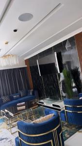 a dining room with blue chairs and a table at Bash luxury apartments in Freetown