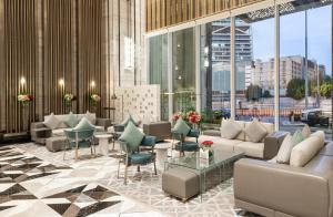 a lobby of a hotel with couches and chairs at Narcissus The Royal Hotel in Riyadh