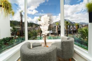 two chairs in a room with large windows at Kemer Royal Beach Hotel in Kemer