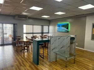 a conference room with tables and chairs and a table at Goya Hotel in Buenos Aires