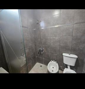 a bathroom with a shower and a toilet at Apartamentos Luz in Mendoza