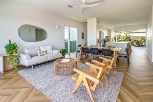 a living room with a couch and a table at Villa Parkana - Beachside Buddina in Buddina