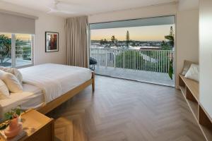 a bedroom with a bed and a large window at Villa Parkana - Beachside Buddina in Buddina +44 photos