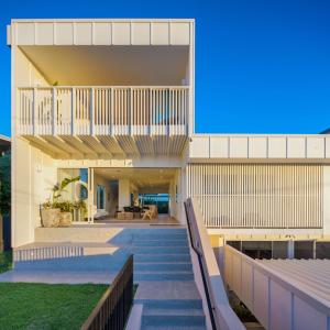 a house with a staircase leading up to it at Villa Parkana - Beachside Buddina in Buddina