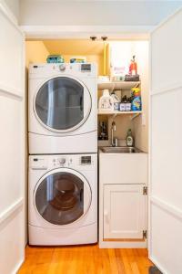 a small kitchen with a washing machine and a sink at Secret Garden Stay - Perfect SF Location in San Francisco