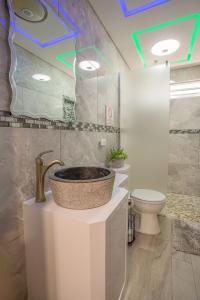a bathroom with a sink and a toilet at EcoMar Rentals Casa:, Naturaleza, Piscina & Playa in Cabo Rojo