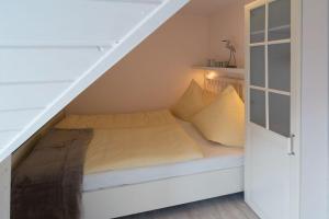 - une chambre avec un lit sous les escaliers dans l'établissement Fewo-Gyde-3-Haustiere-erlaubt-WLAN-kostenlos, à Norddeich