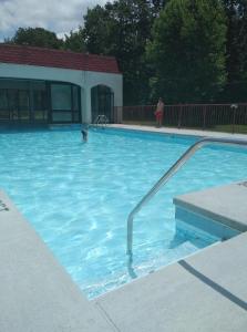 a large swimming pool with a person in the water at Econo Lodge Inn & Suites in Norton