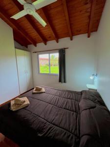 a bedroom with a large bed with a ceiling fan at Hotel Aimara in Mina Clavero +35 photos