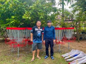 two men are standing in front of some nets at Pano Solar Guest House (พาโน โซล่า เกสเฮ้าส์ ) in Trat