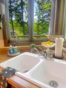 fregadero blanco en una cocina con ventana en 2br Lakeside Haven Relax On Long Lake, en Gleason