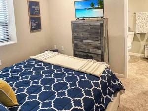 a bedroom with a bed and a tv on a dresser at Cozy 3br Downtown Bakery & Shops! in La Crosse