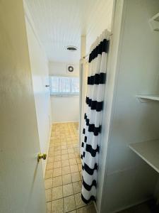 a hallway with a black and white shower curtain at Excelsior at the Manor House in Clemmons